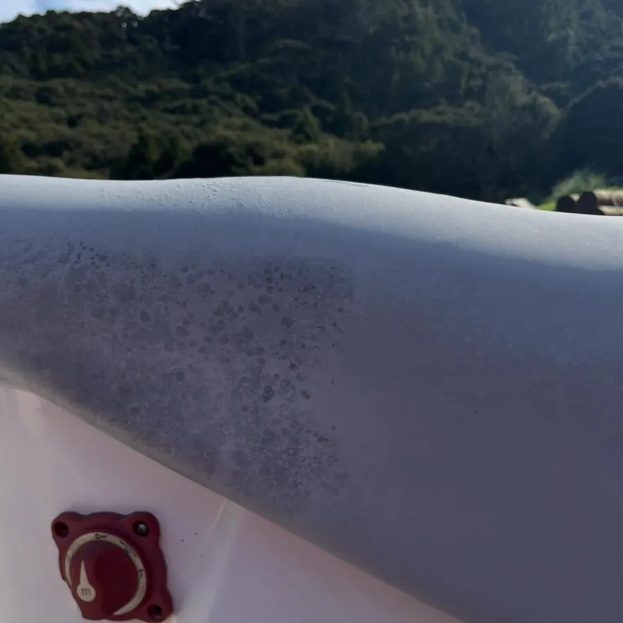 Grey inflatable tube with dark mould spotting on the left, cleaned on the right